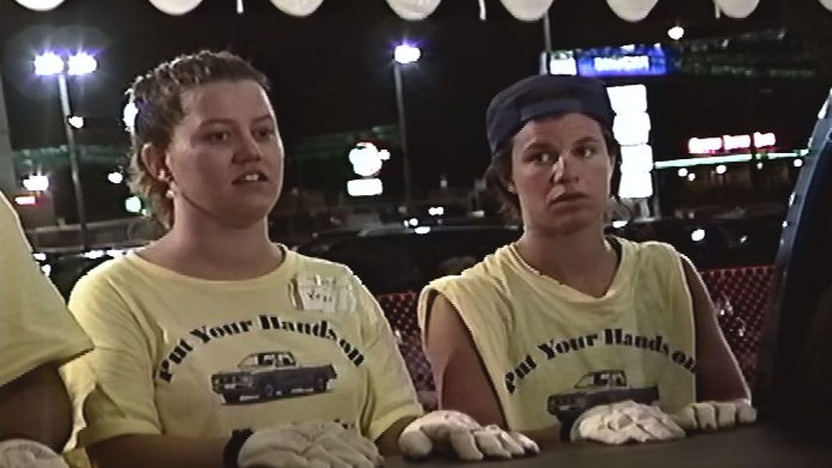 Two contestants at the truck at night